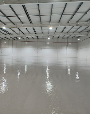 Zareeq Coating technicians applying epoxy floor layer